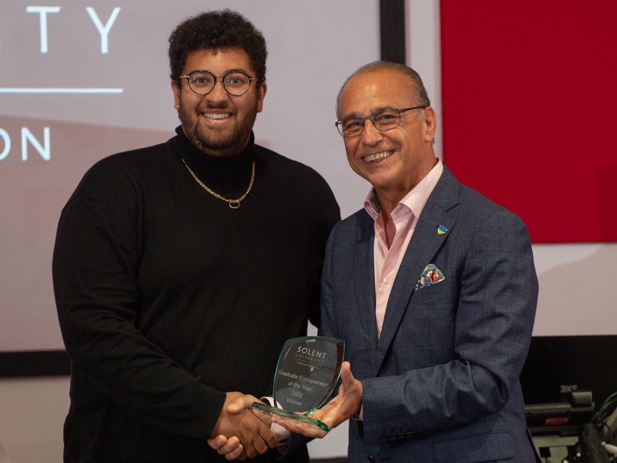 James Gayle receiving an award from Theo Paphitis